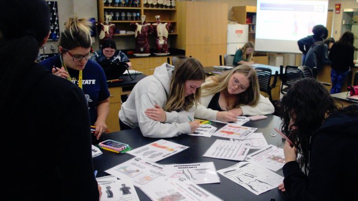 Science students participating in group activity.