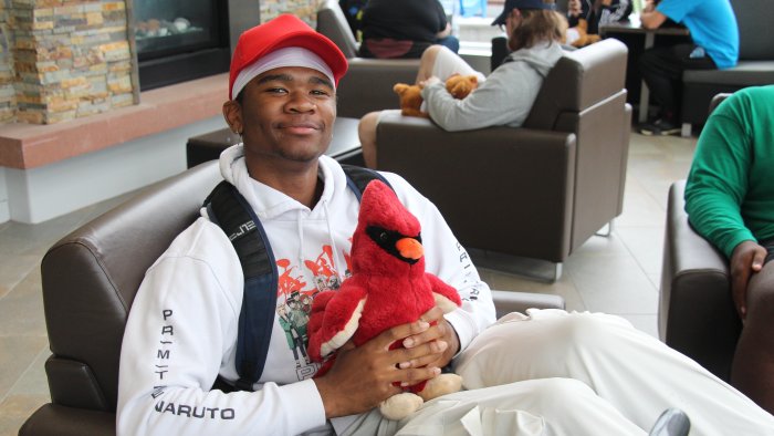 Student poses with his new stuffed cardinal