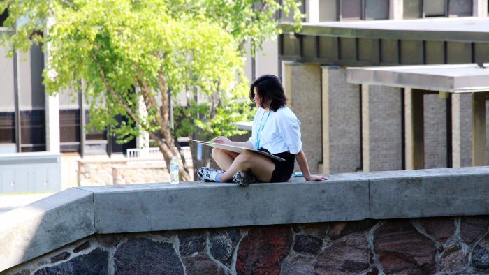 Alfred State student finds a spot to study outside the library.