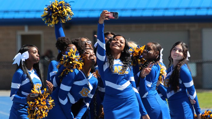 Alfred State Cheerleaders take a selfie on the sidelines.