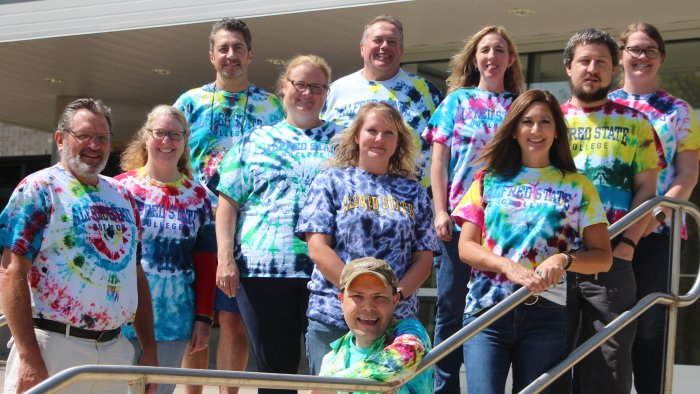 Members of the School of Arts and Sciences Faculty show off their new tie-dye shirts.
