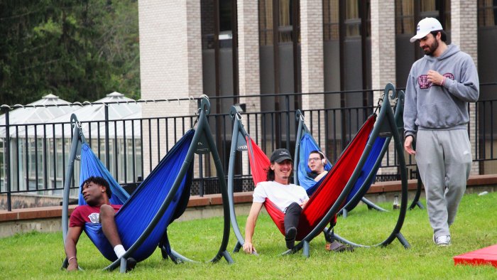 Students relaxing in hammocks during Week of Welcome.