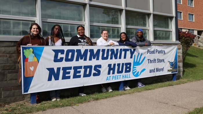 Staff and Student Workers pose in front of new Community Needs Hub.