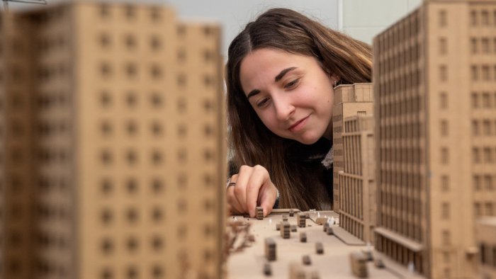 Female student works with architecture model.