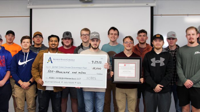 Surveying students presented with $10,000 award.