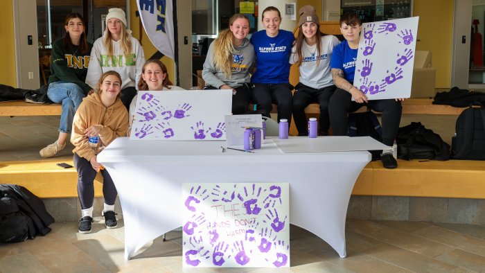 Students promote domestic violence awareness.