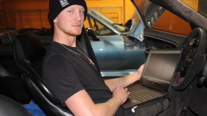 Student uses laptop to monitor car