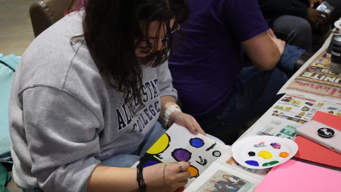 Student painting on canvas.