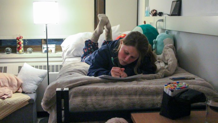 Student studies in her dorm room