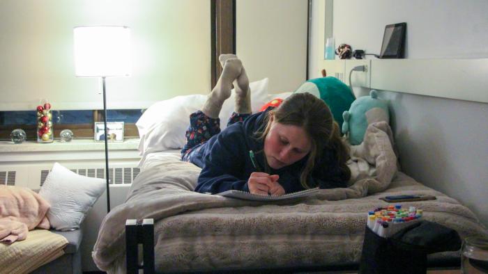 Student studies in her dorm room