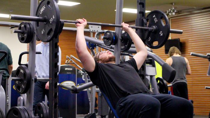 Student lifting weights