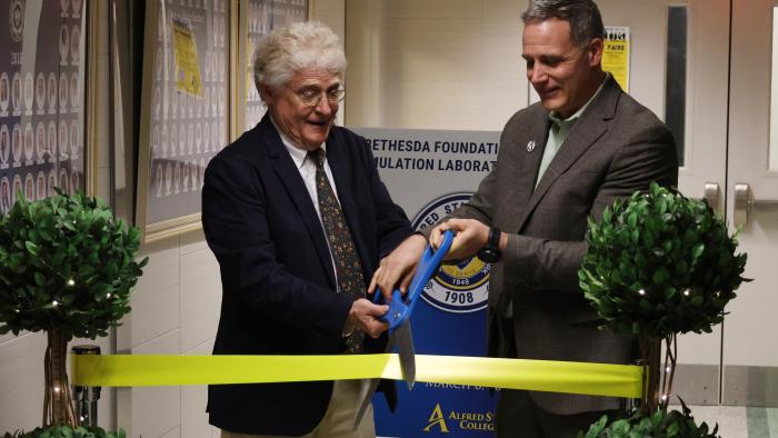 President Mauro cuts the ribbon for a new lab.