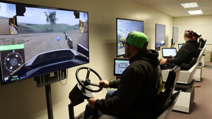 Student tests out the new heavy equipment simulator.