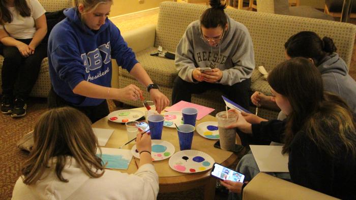 Students paint canvases 