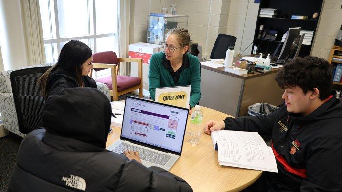 Students works with a peer tutor and professional staff in the math lab