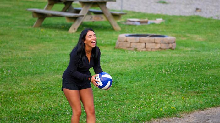 Student having fun playing volleyball