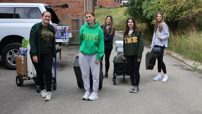 Sisters of Pi Nu Epsilon help during move-in