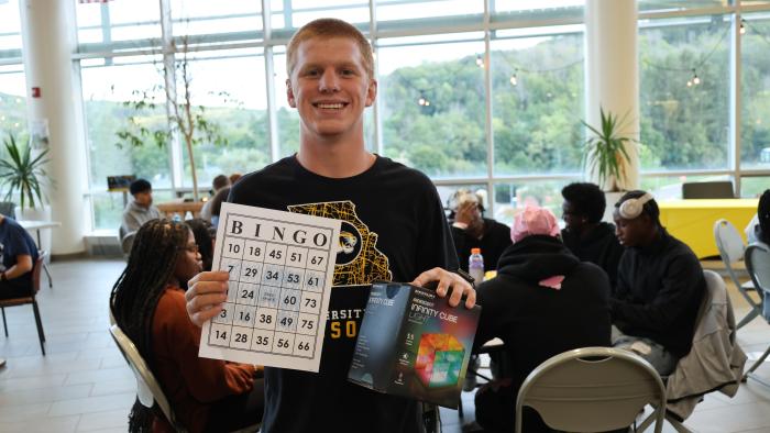 Student shows off his prize from Bingo