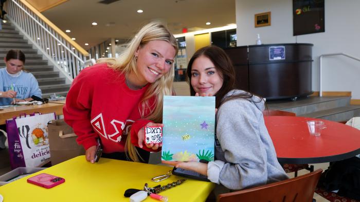 Students show off their canvas art