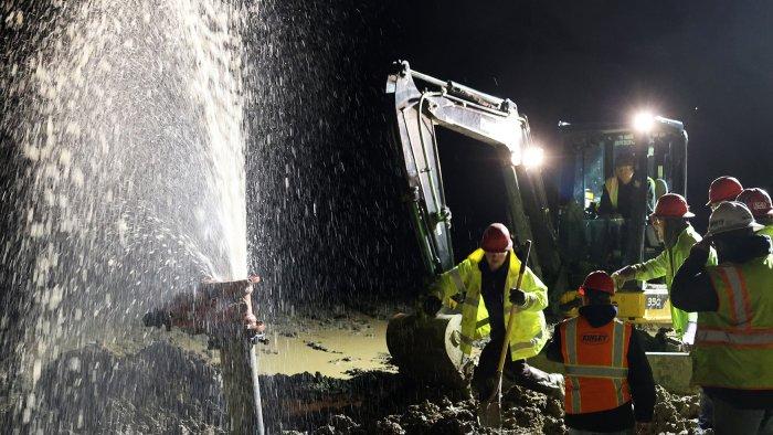 Heavy equipment students work on a water main break simulation