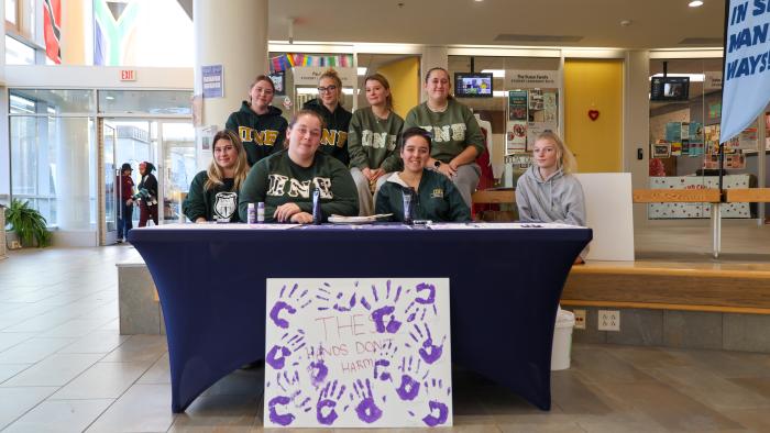 SIsters of Pi Nu Epsilon at tabling event