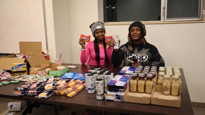 Members of the Campus Activities board giving away snacks and drinks