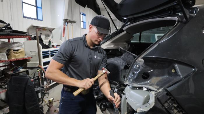 Automotive student working on a car