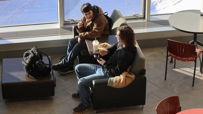 Two students enjoying a snack between classes.