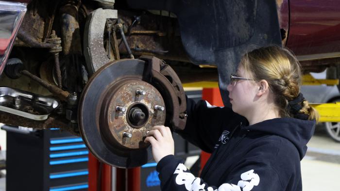 student works on a car in lab