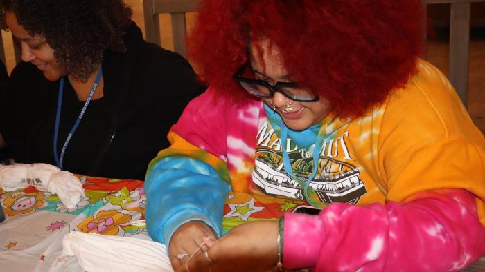 student tie dyes clothes