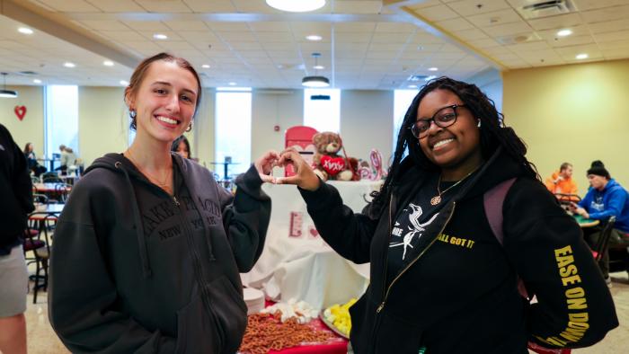 Students make a hand heart for Valentine's Dinner