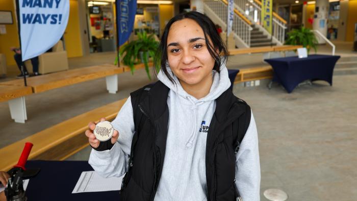 Student poses with Black History Month pin that she made