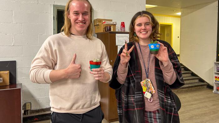 Students pose with their creations
