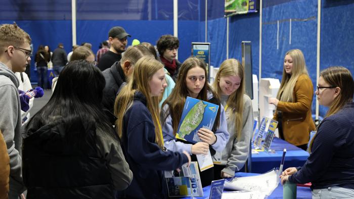 Accepted students ask questions at resource tables