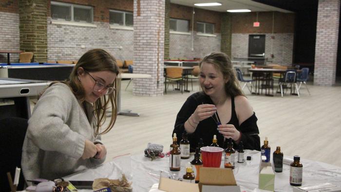 Female students making their own fragrances