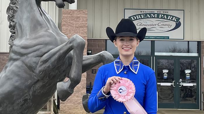 Ashley Wolfe displays her fifth-place ribbon. 
