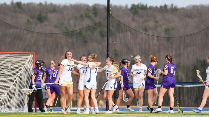 Members of Alfred State Women's Lacrosse celebrate a goal