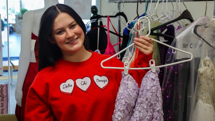 Female student shows off prom dresses for annual Project Prom Dress event