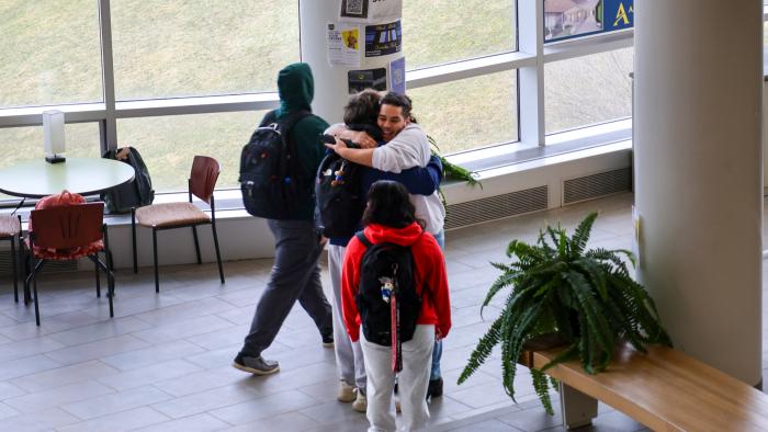 Students embrace in Student Leadership Center