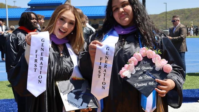 Two female students celebrate becoming First Generation graduates