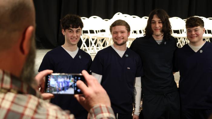 Parent takes photo of Allied Health Students 