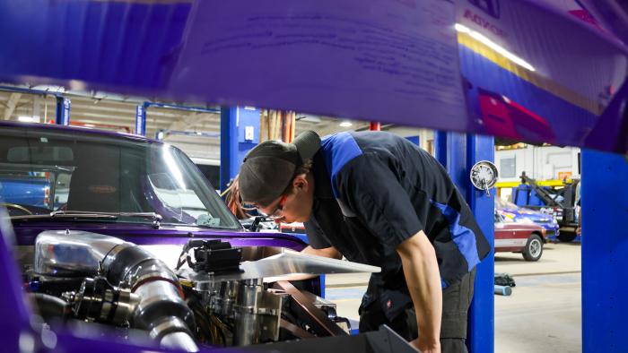Student works on a kit car engine