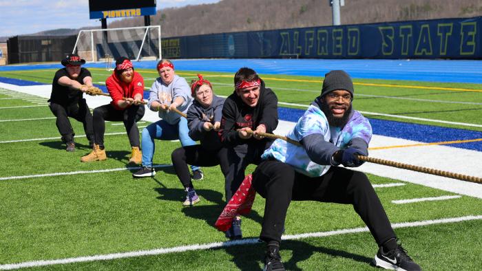 Alfred State students participate in a tug of war