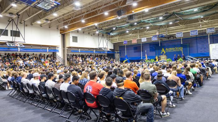 Carrie Cokely addresses new students.