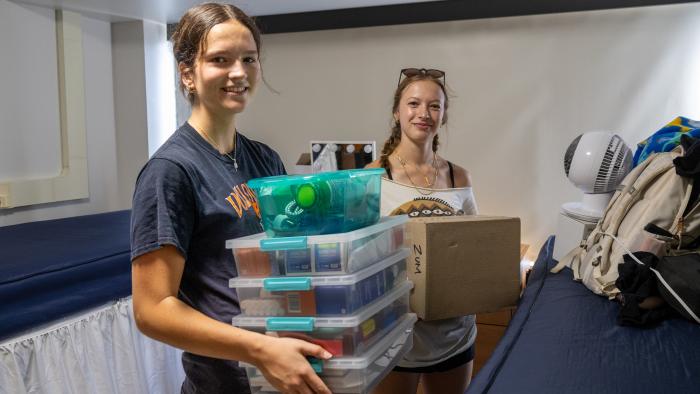 Two students moving into their new residence hall