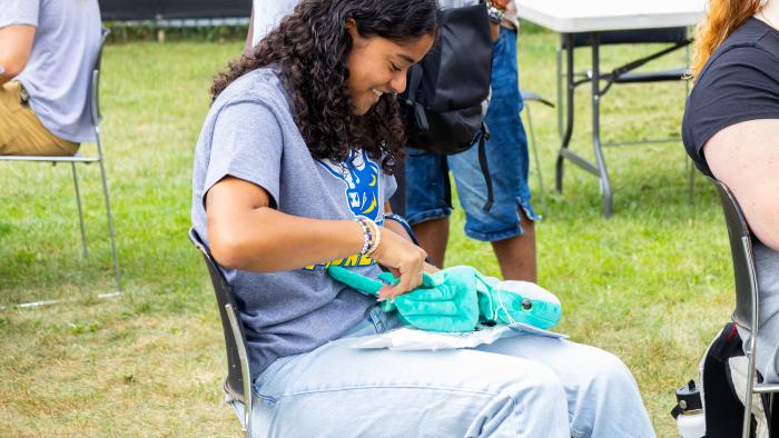 Female student makes her own stuffed-turtle.