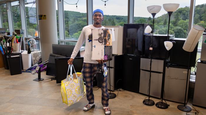 Male student shows off his Mega Sale purchases