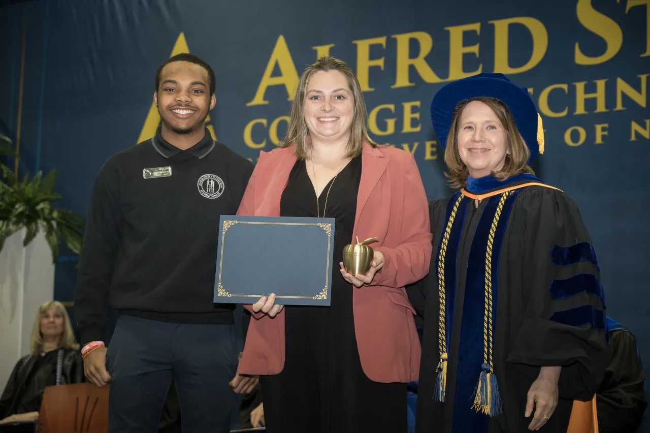 Danielle Merring was honored with an award, presented by Jalon Rainey and Carrie Cokely