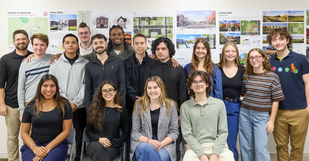 Professor DiRado's studio group posing in front of their concepts.