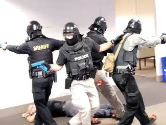 police and sheriff wearing masks and training guns for a drill